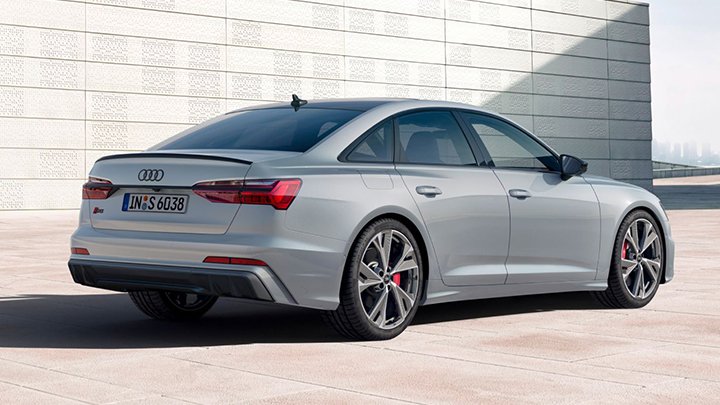 Back of grey Audi S6 Saloon parked in front of a grey wall