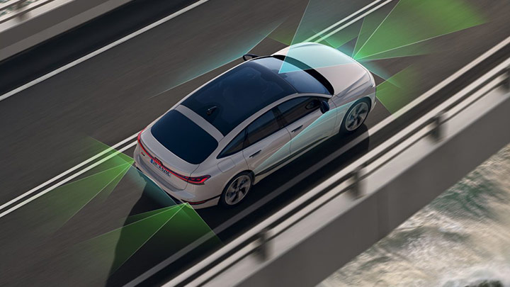 White S6 Sportback e-Tron driving in a tunner with lights front headlights flashing through