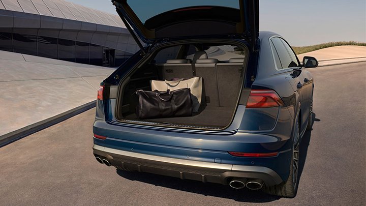 Interior of a blue Audi SQ8. The car is parked with a modern building to the left side
