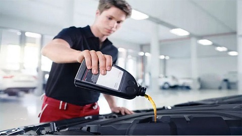 Technician Changing Car Oil