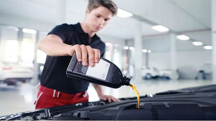 Technician Changing Car Oil
