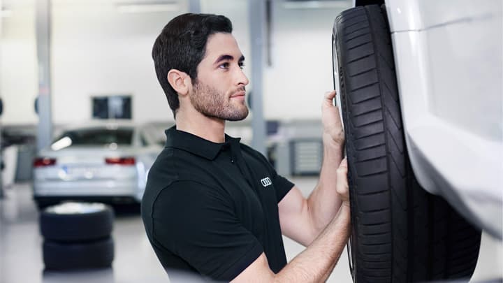 Audi technician removing the wheel from an Audi