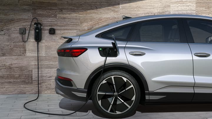 Silver Audi e-tron being charged