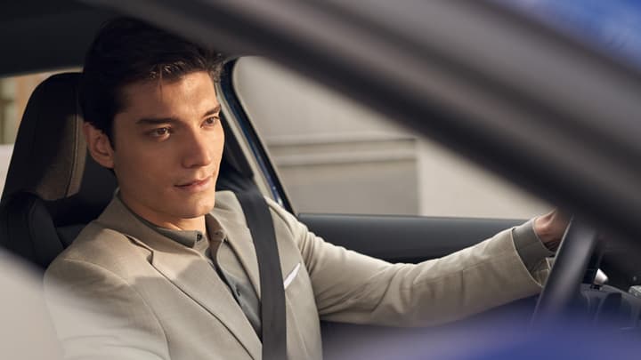 Young man sat in the driver's seat of an Audi e-tron
