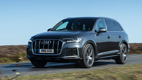 Grey Audi Q7 driving down a country road