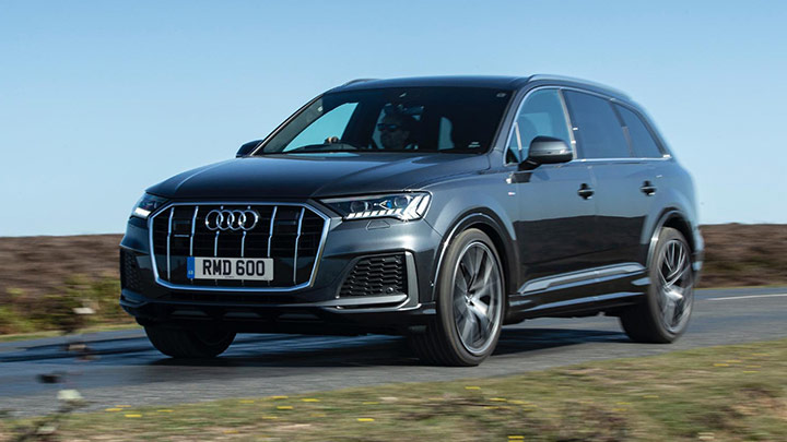 Grey Audi Q7 driving down a country road