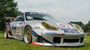 Porsche GT3 in grey parked on the grass.
