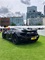 Rear view of the McLaren MP4-12C in black on the grass at the London Concours 2019.
