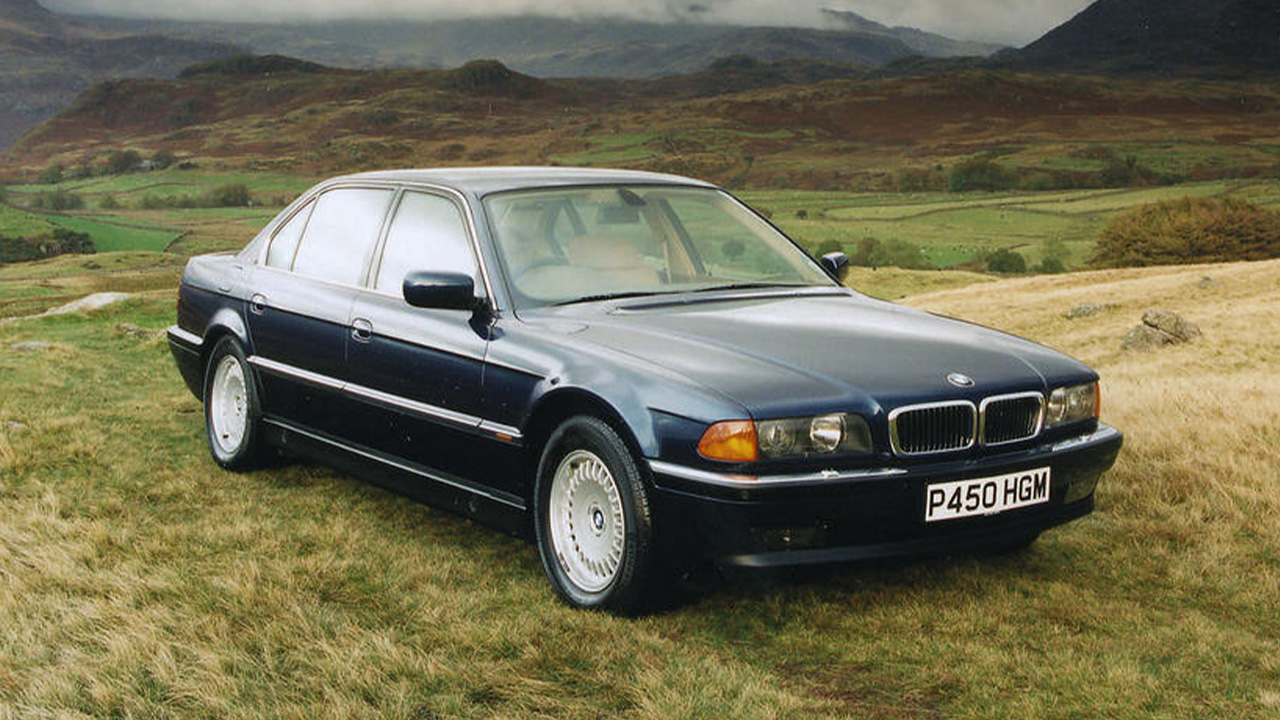 Blue BMW 7 Series, parked in countryside