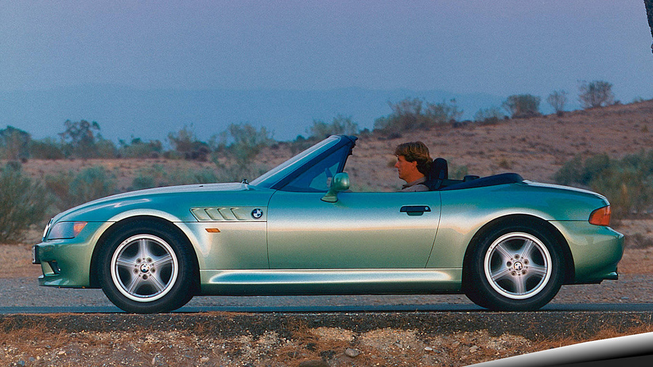 Green BMW Z3, side profile with roof down