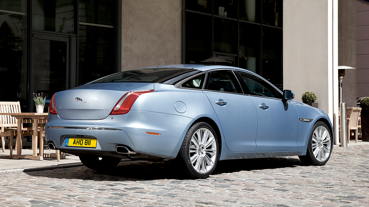 Blue Jaguar XJ, parked on cobbles