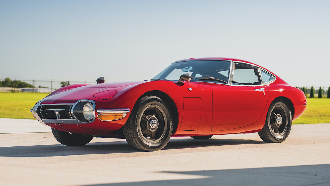 Red Toyota 2000GT, driving on a runway