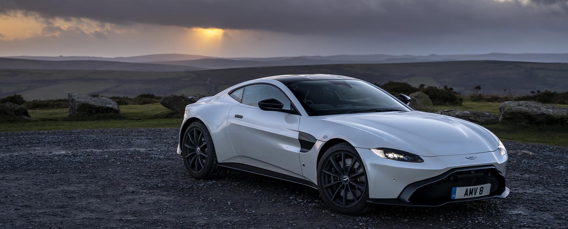 Grey Aston Martin Vantage, parked in sunset
