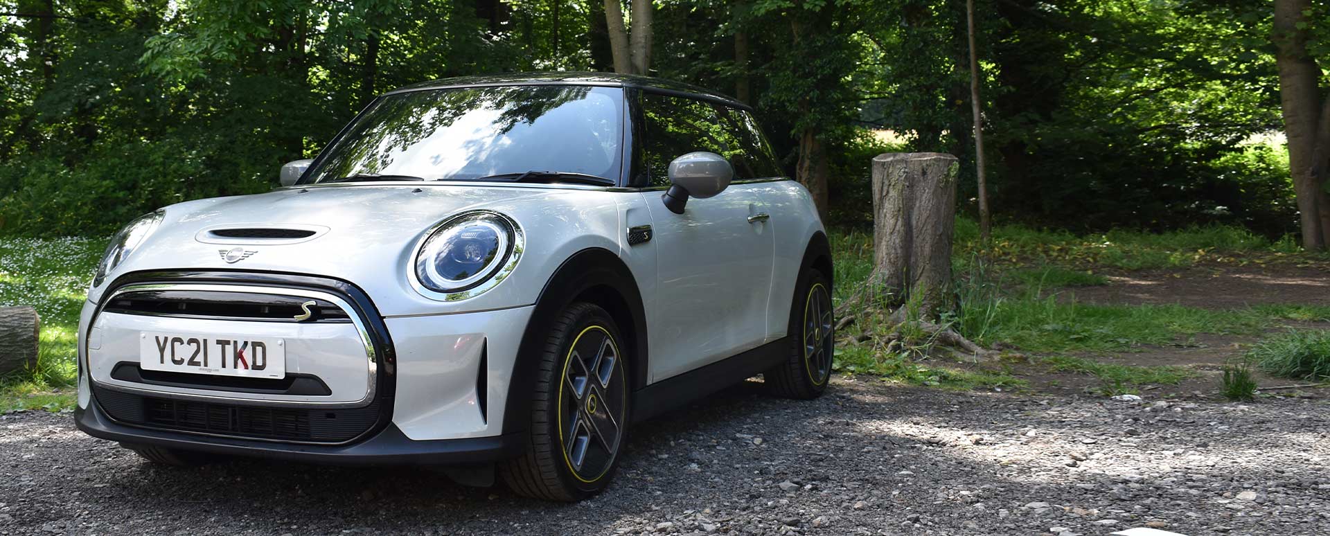 MINI Electric, front quarter shot, parked in front of woodland