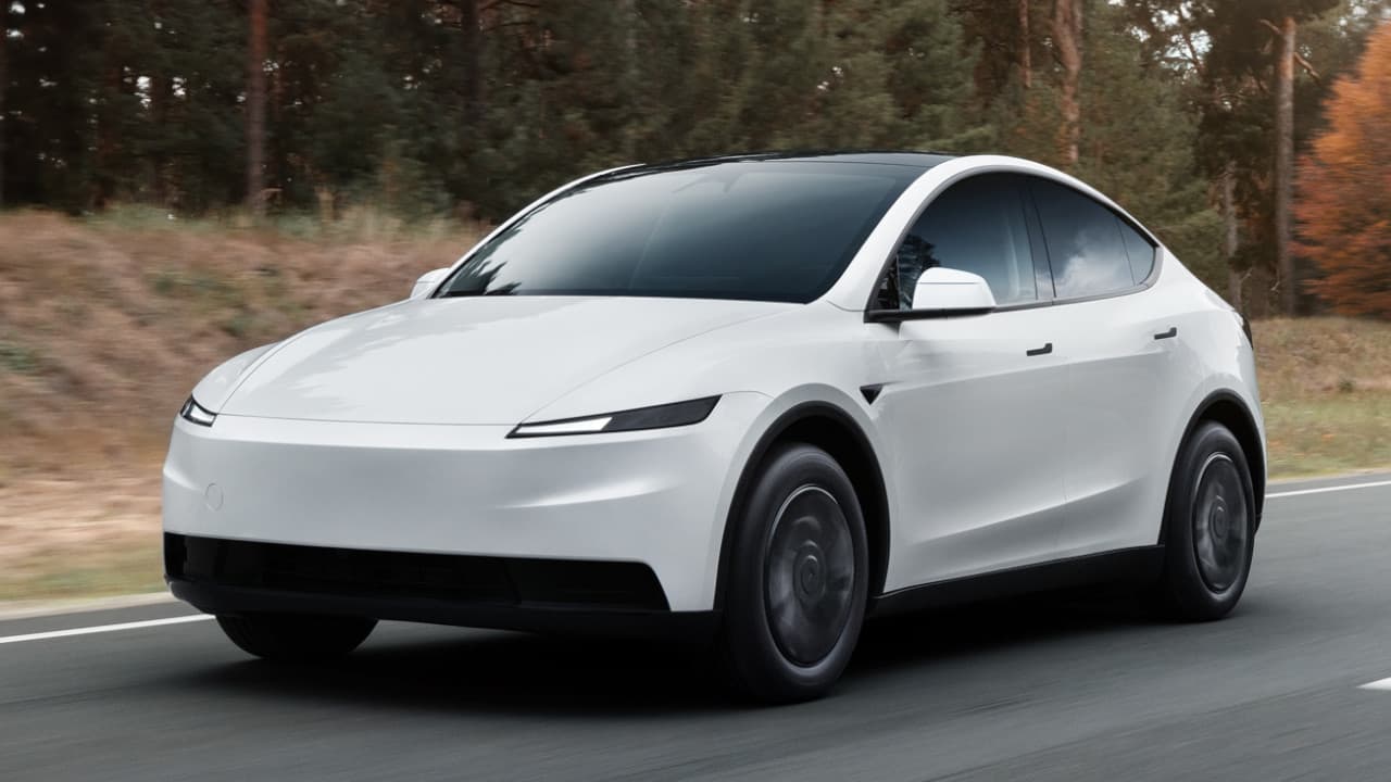 Tesla Model Y in White Driving