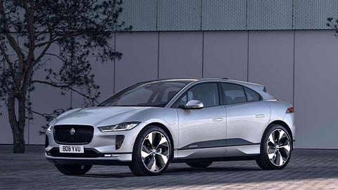 jaguar i-pace parked in front of tree