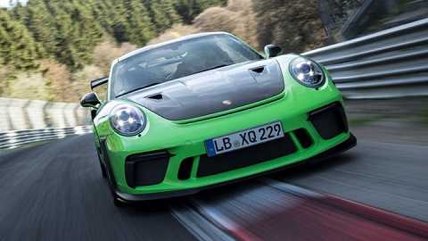 Green Porsche 911 GT3 RS driving around Nürburgring
