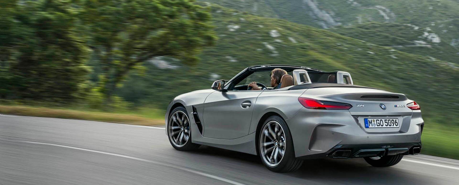 Grey BMW Z4 M40i driving in the countryside with the roof retracted