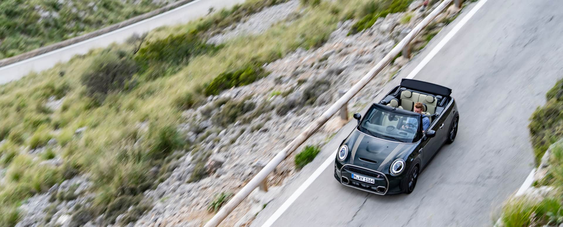 Aerial Image of Black MINI Convertible Driving on Mountain Road