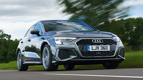 Grey Audi A3 Sportback rolling shot, driving down a country road