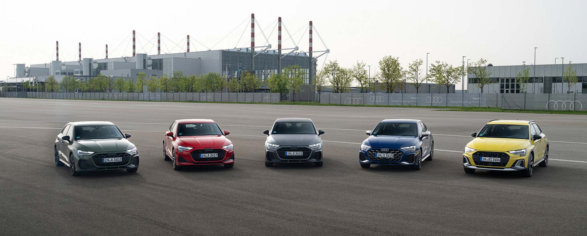 Five Audi A3 Cars Lined Up in Industrial Area