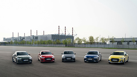 Five Audi A3 Cars Lined Up in Industrial Area