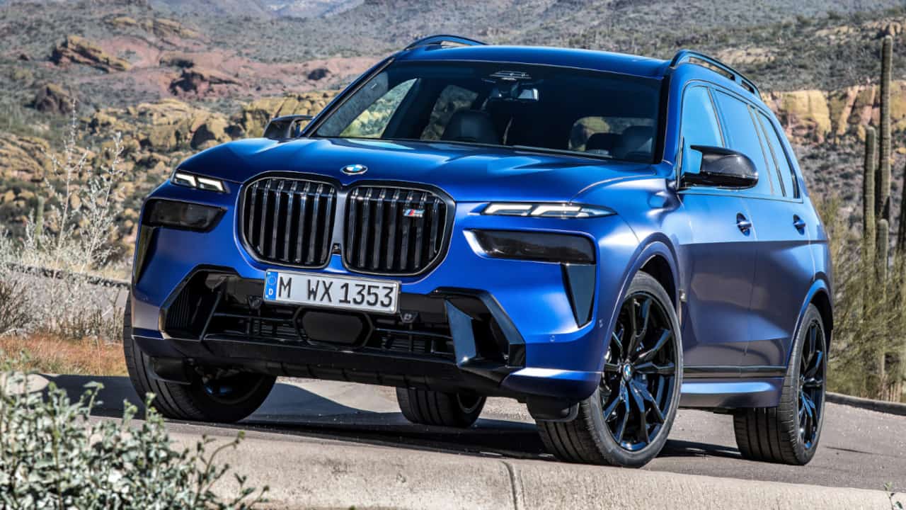 BMW X7 M60i in Blue Parked at an Angle