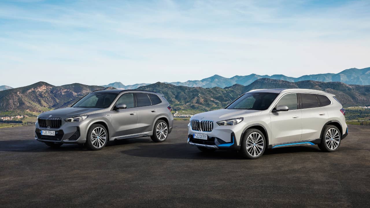BMW X1 M35i in Grey with BMW iX1 in White with Mountains in Background