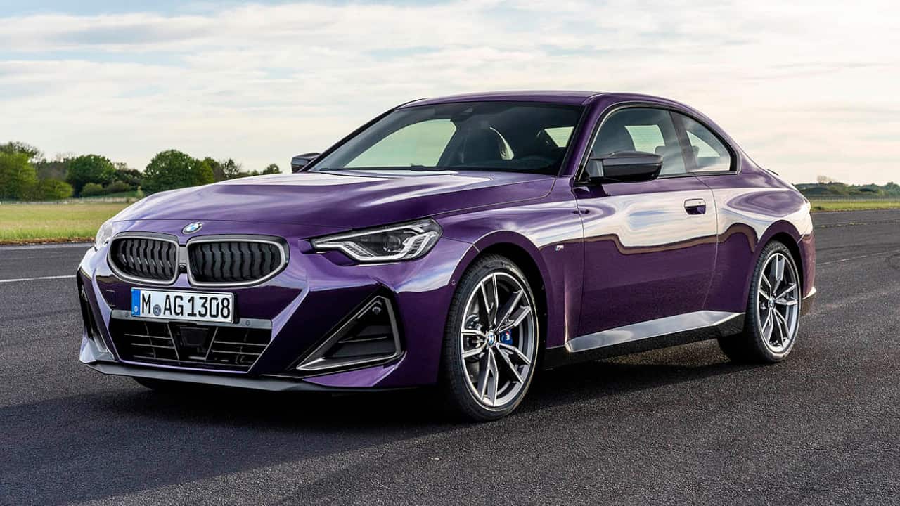 Purple BMW 2 Series driving in the countryside