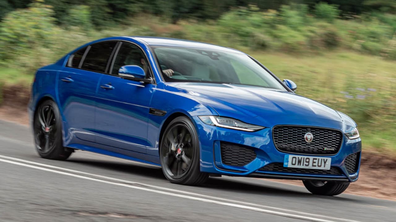 Blue Jaguar XE driving in the countryside