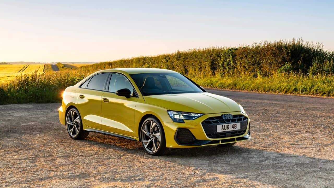 Yellow Audi A3 parked in front of the sunset landscape