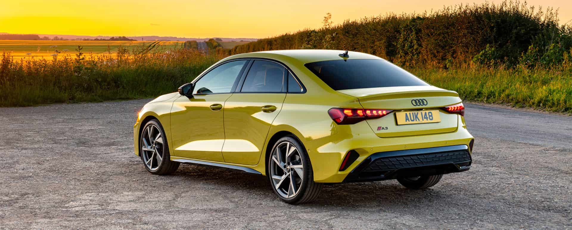 Yellow Audi A3 parked in front of the sunset landscape