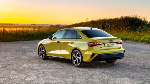 Yellow Audi A3 parked in front of the sunset landscape
