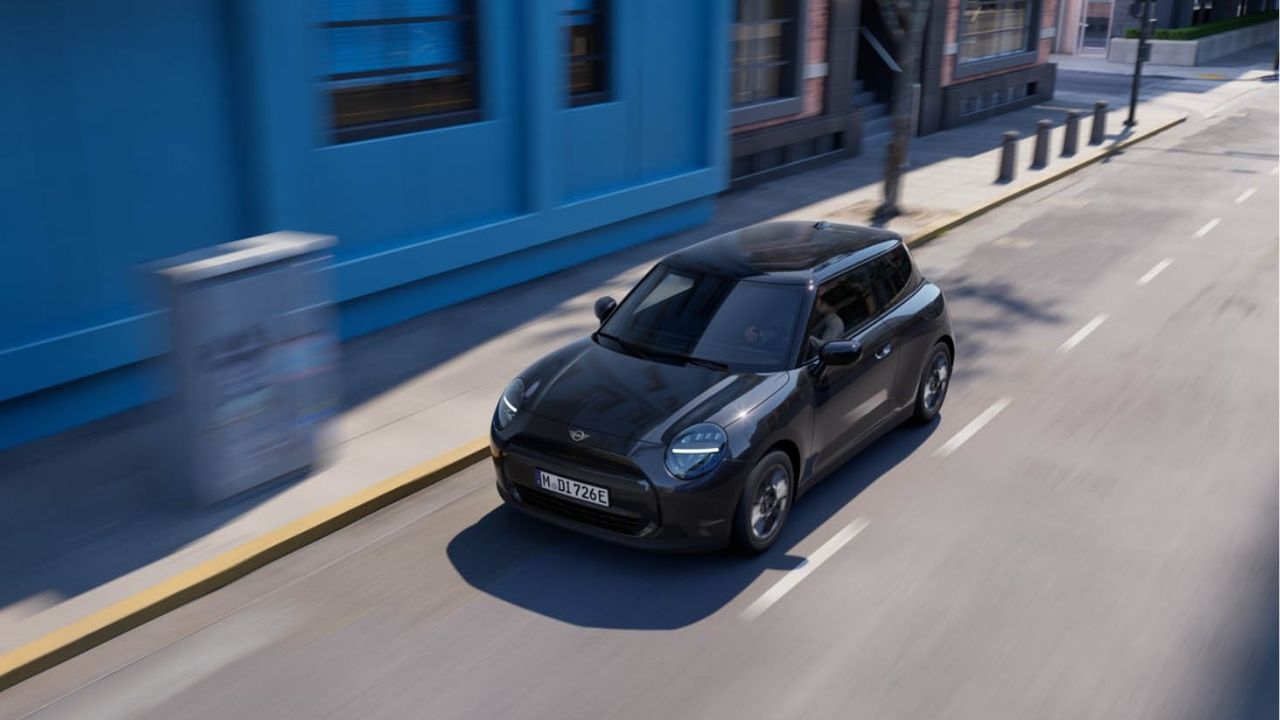 Black MINI Cooper electric driving in the city