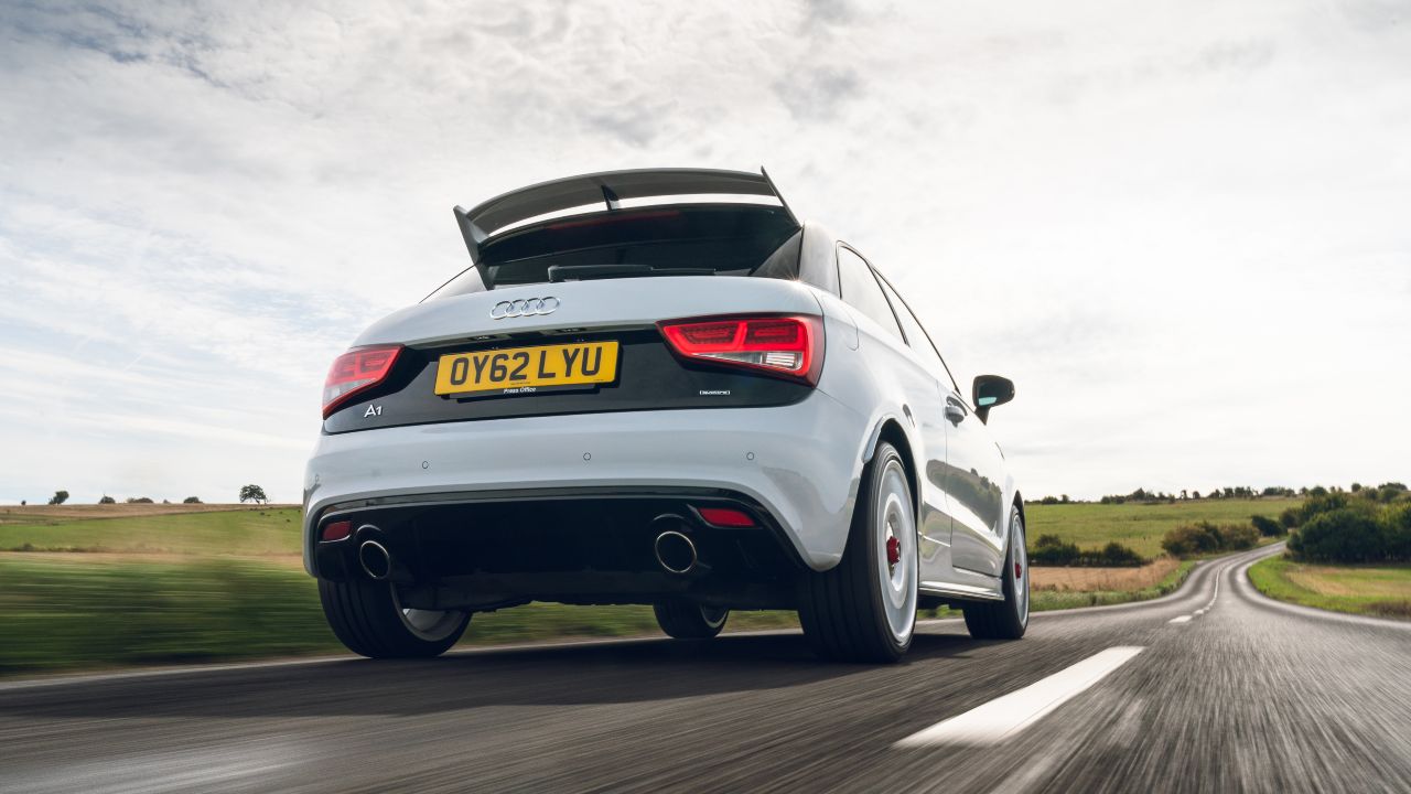 Audi A1 quattro driving on country road, rear three-quarter view