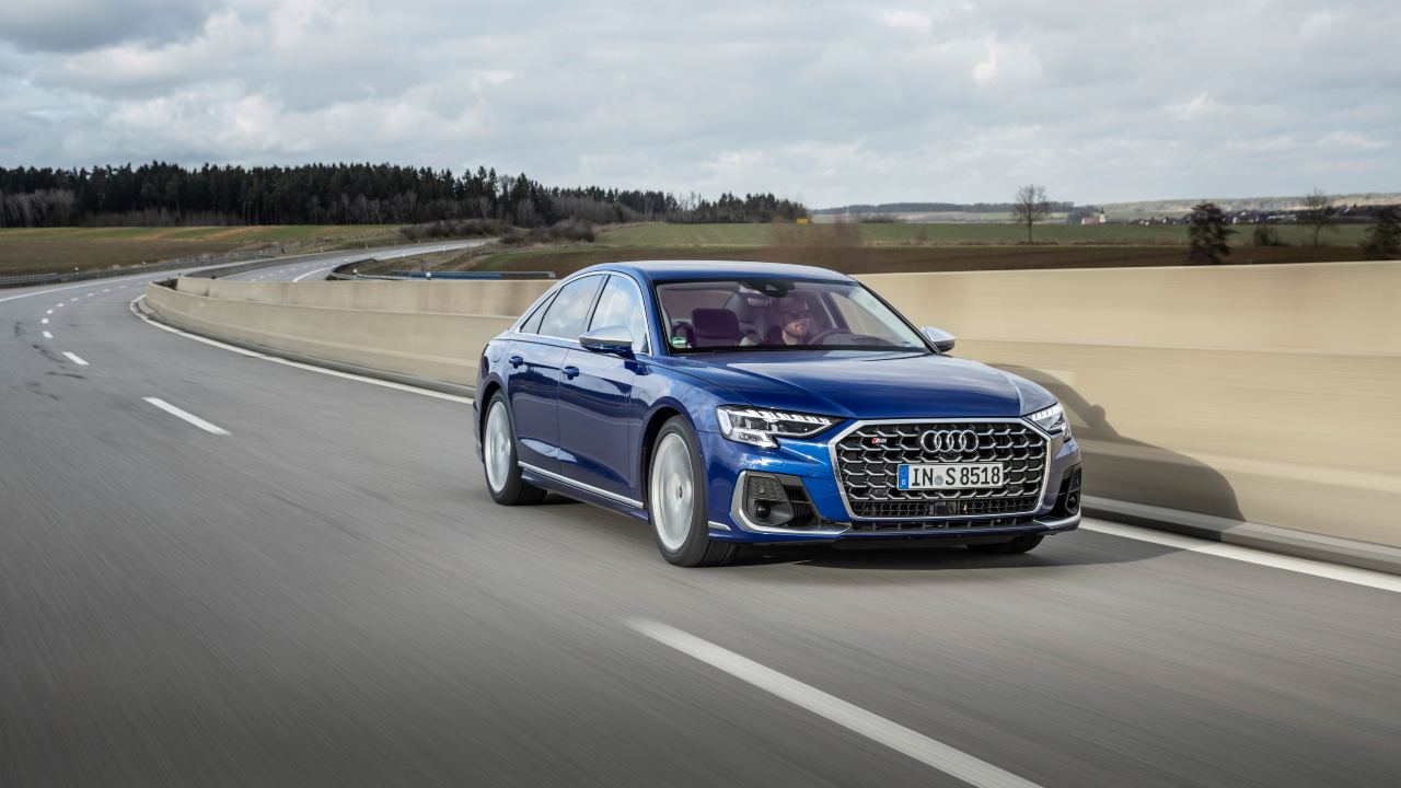 Audi S8 performance saloon driving on motorway, front three-quarter view