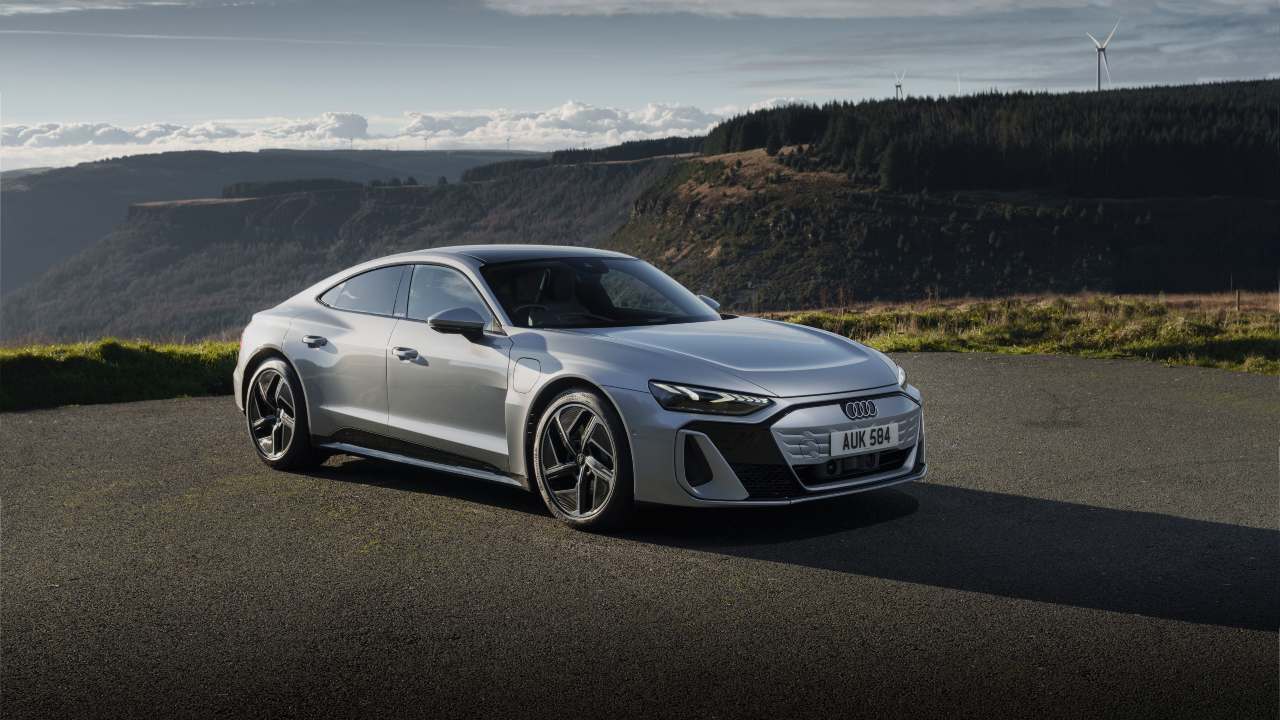 Audi e-tron GT electric saloon parked with scenic hillside backdrop