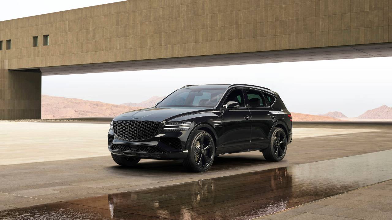 Black Genesis GV80 parked outside a modern building