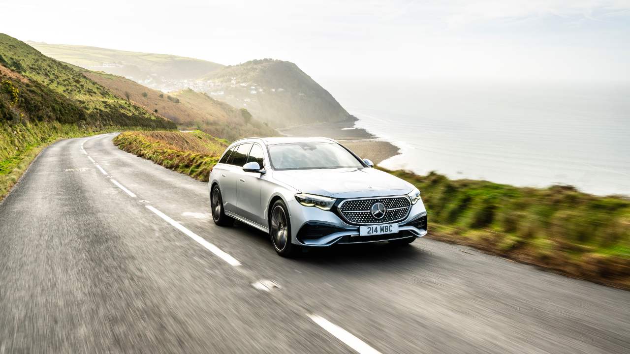 Silver Mercedes-Benz E-Class Estate driving along a coastal road