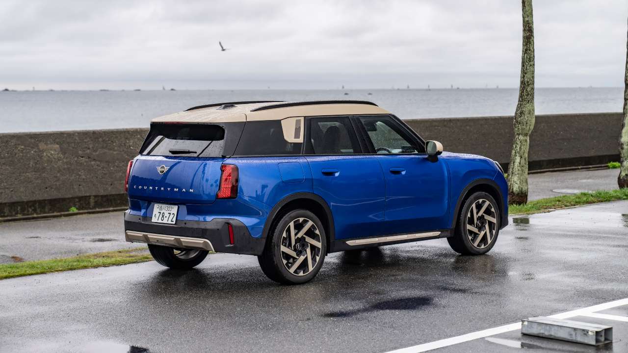 Blue MINI Countryman parked by the seafront, rear view