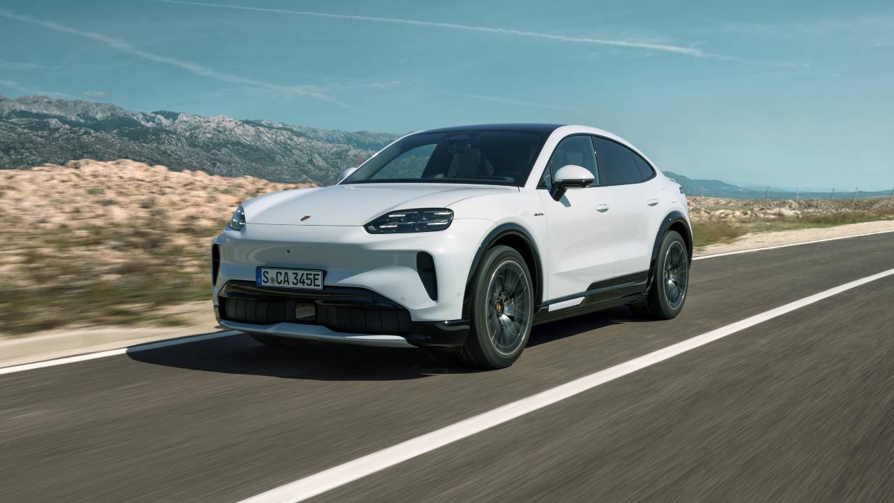 White Porsche Cayenne Coupe Electric driving on a coastal road