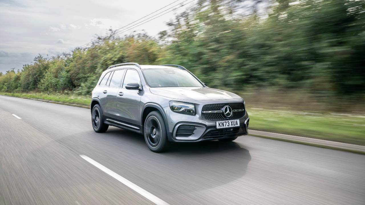 Mercedes-Benz GLB SUV driving along a rural road with motion blur background
