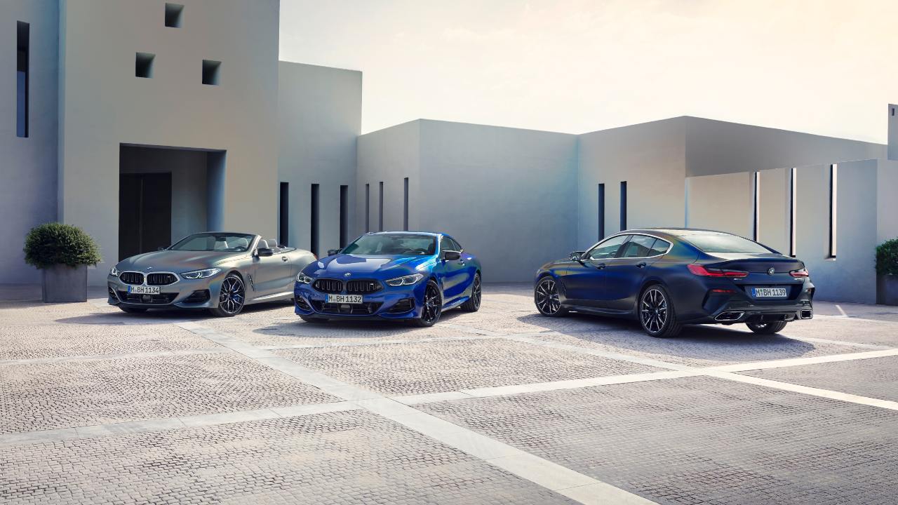 BMW 8 Series range including coupe, convertible and gran coupe models parked in a modern setting