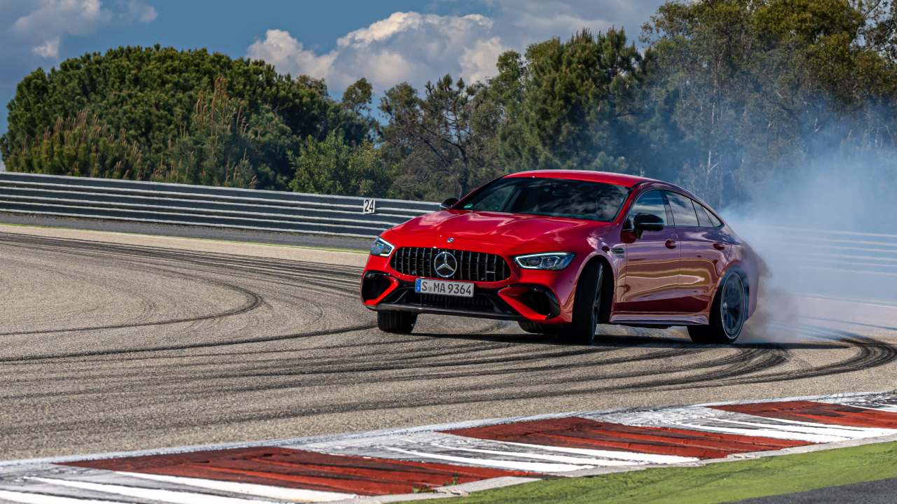 Mercedes‑Benz AMG GT 4‑Door Coupe drifting on a race track with tyre smoke
