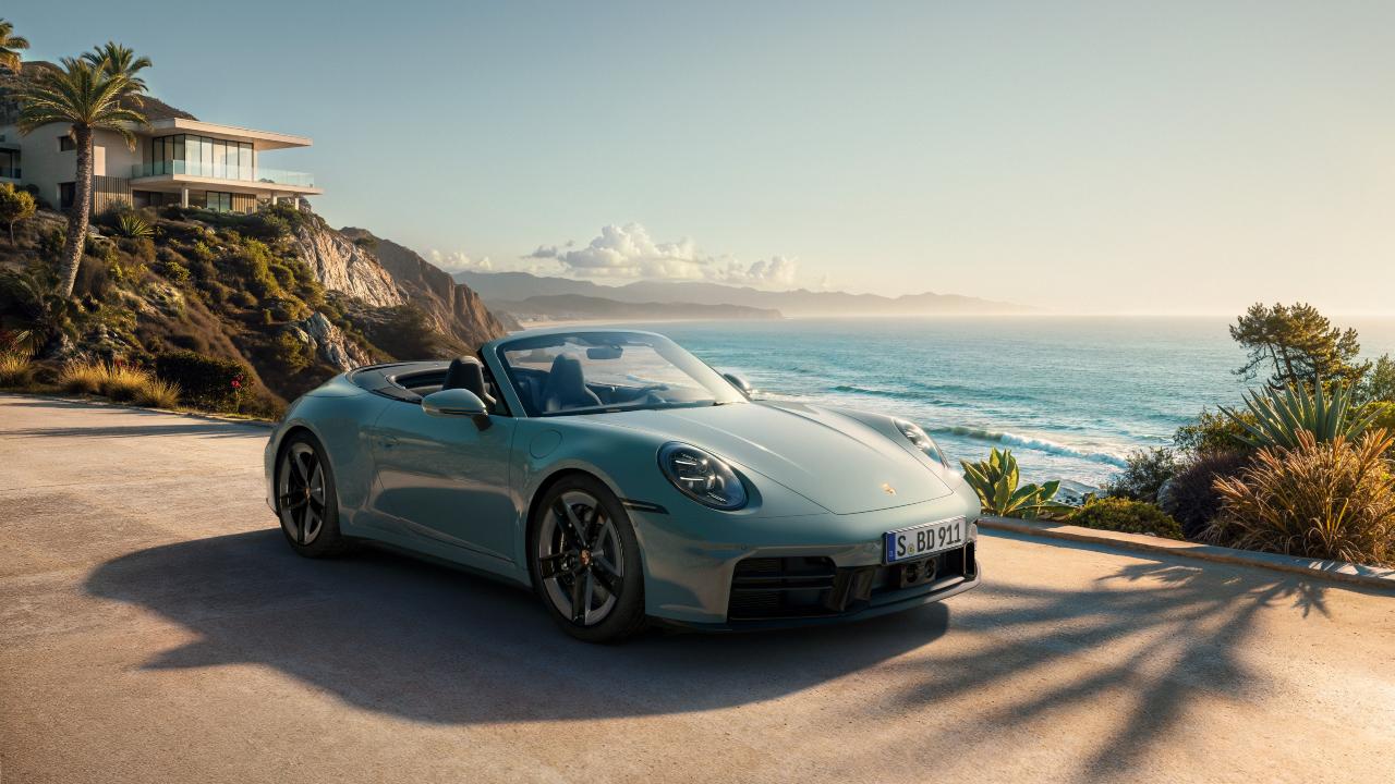 Porsche 911 Carrera 4S convertible parked by the coast in a scenic setting