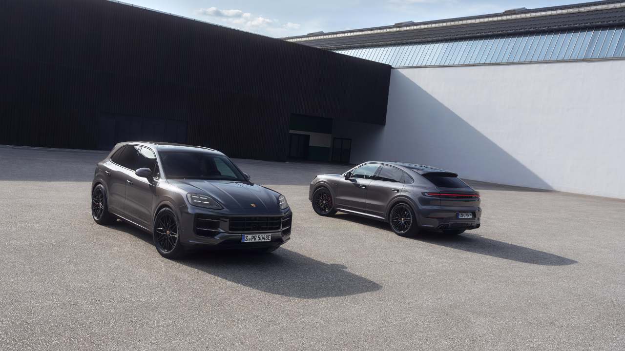 Porsche Cayenne and Cayenne Coupé parked outside modern building