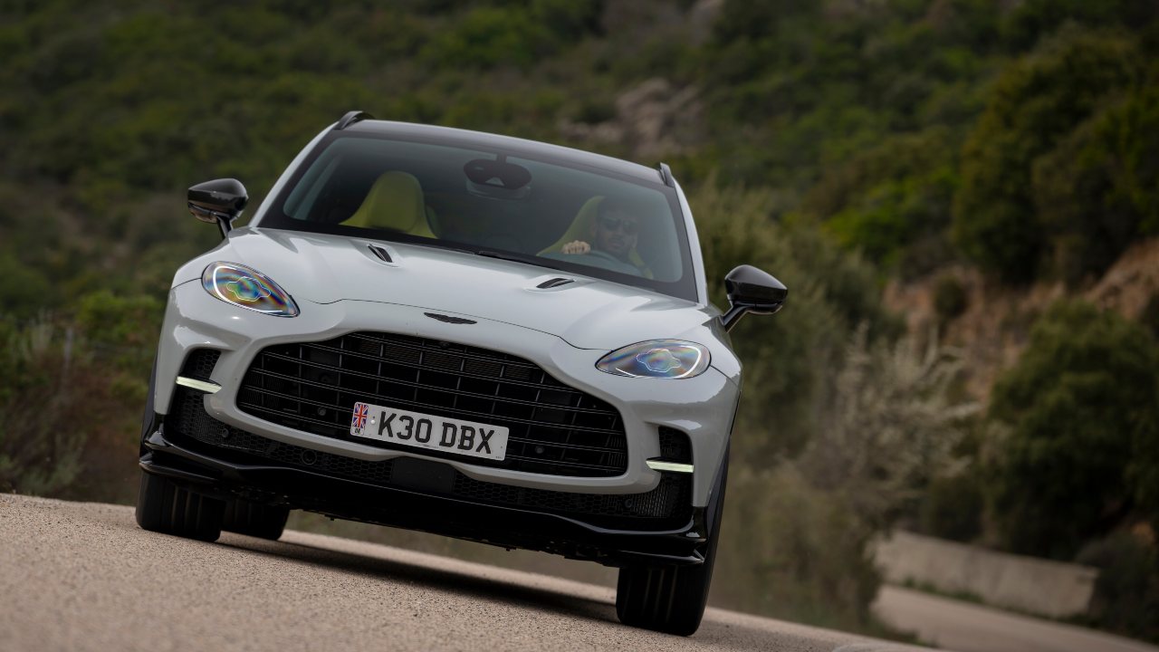 Aston Martin DBX front view driving on curved mountain road