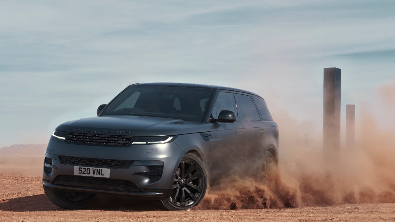Range Rover Sport driving off-road kicking up dust in desert terrain