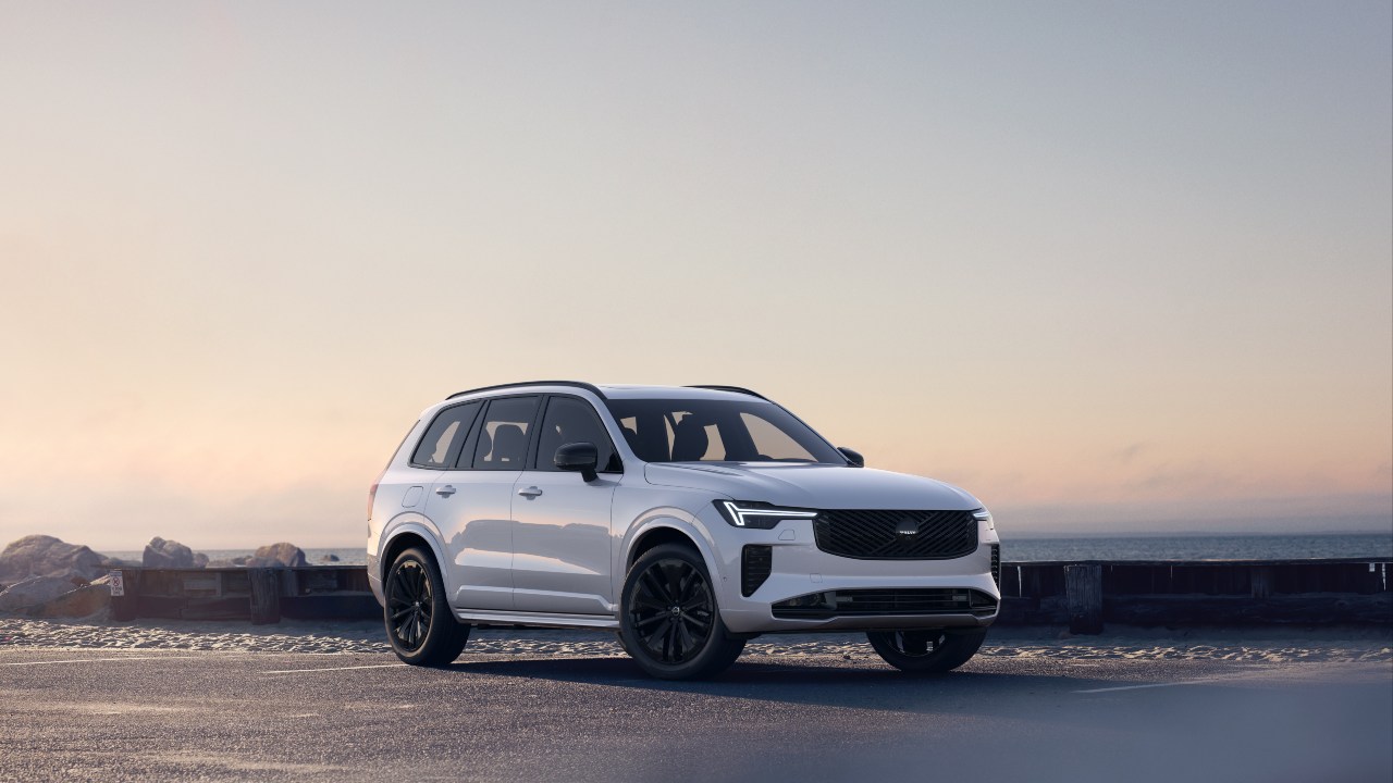 Volvo XC90 parked by the coast at sunset with ocean backdrop
