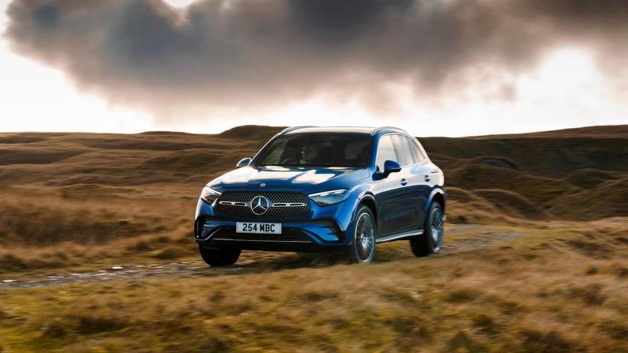Mercedes-Benz GLC SUV driving through countryside, front three-quarter view